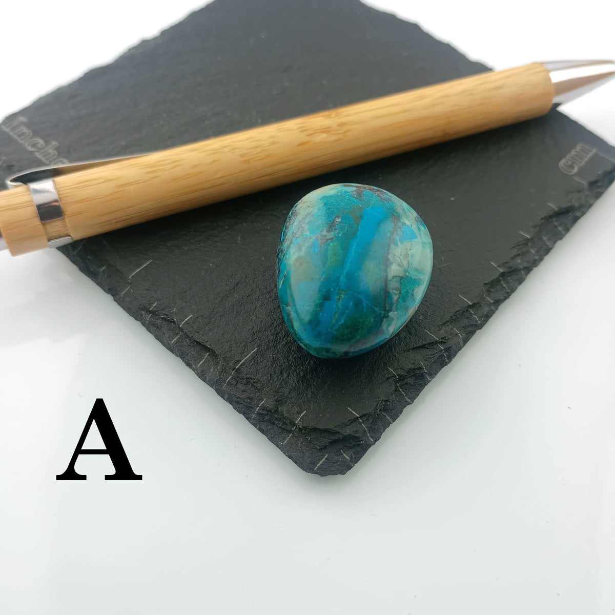 Chrysocolla with Malachite Tumble Stone on a dark slate coaster