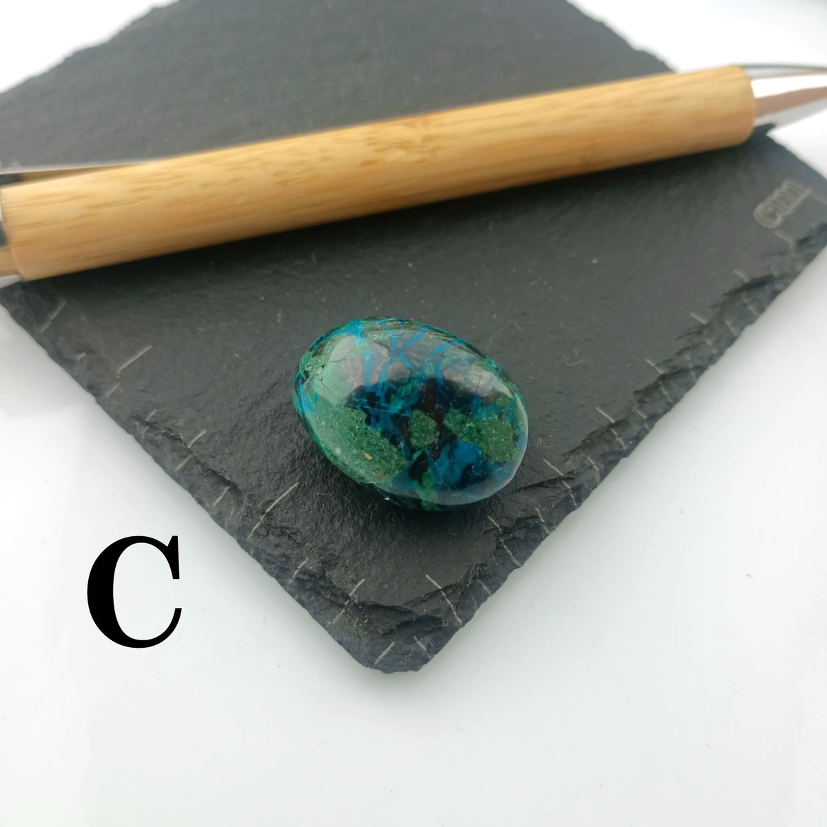 Chrysocolla with Malachite Tumble Stone on a dark slate coaster