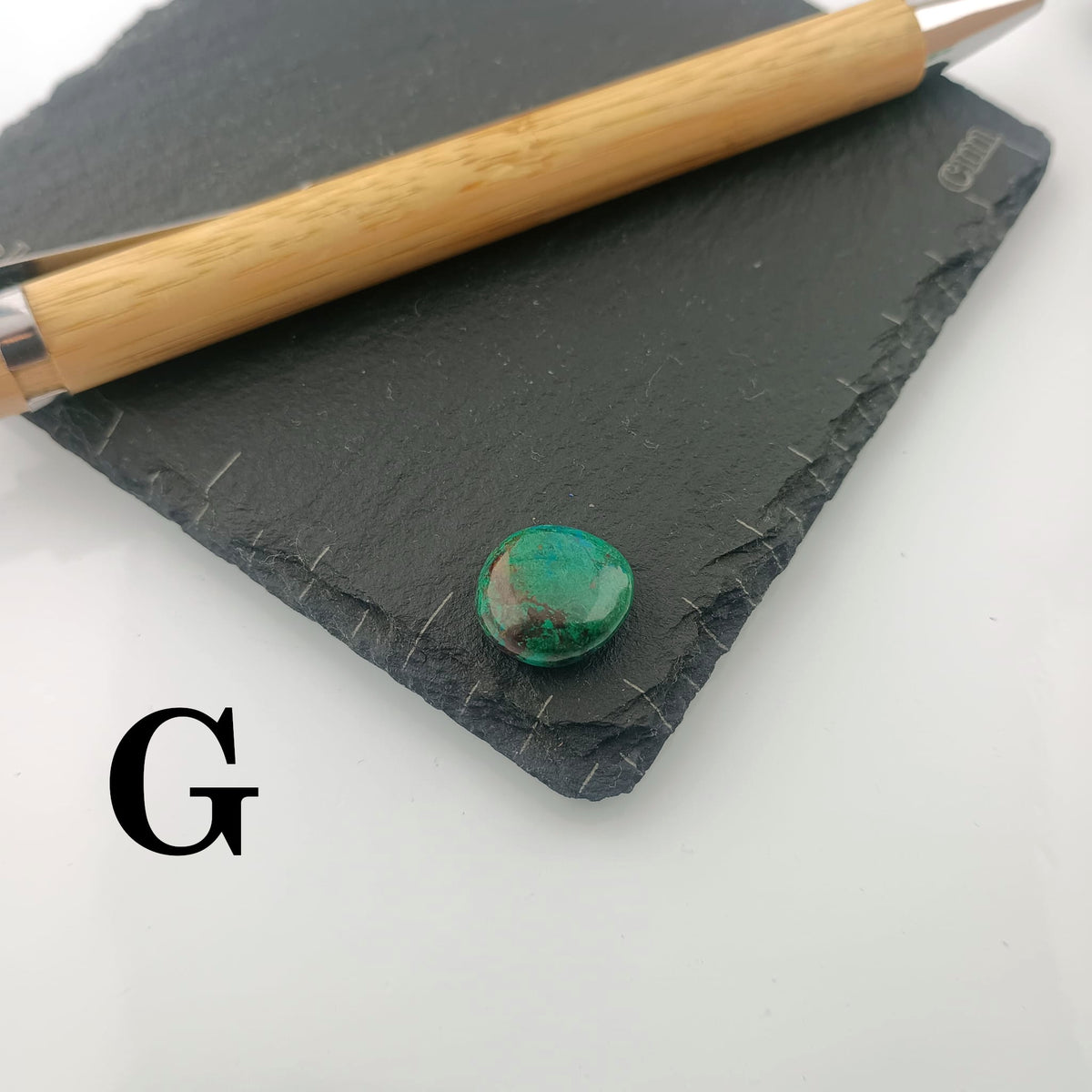 Chrysocolla with Malachite Tumble Stone on a dark slate coaster
