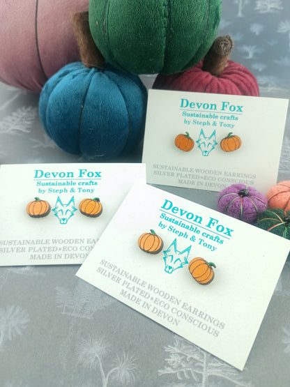 Devon Fox earrings with packaging on a textured surface