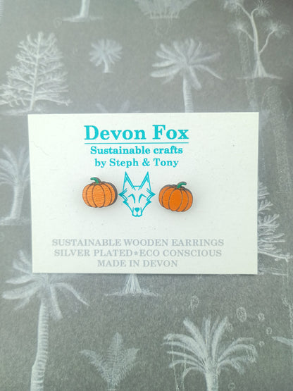 Card with Devon Fox sustainable wooden earrings design on a gray background with floral patterns.