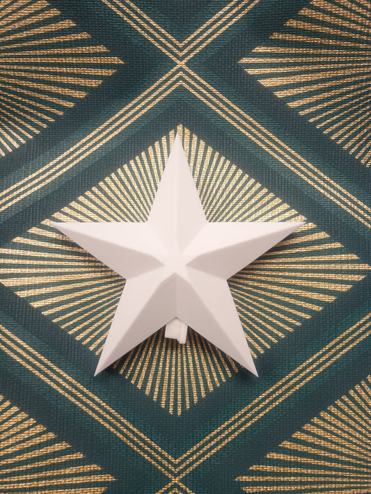 White star-shaped object on a green and gold patterned background